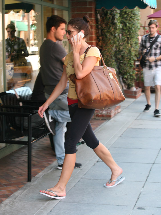 Coach Ashley Greene carries a Coach Bleecker Legacy Weekend Tote