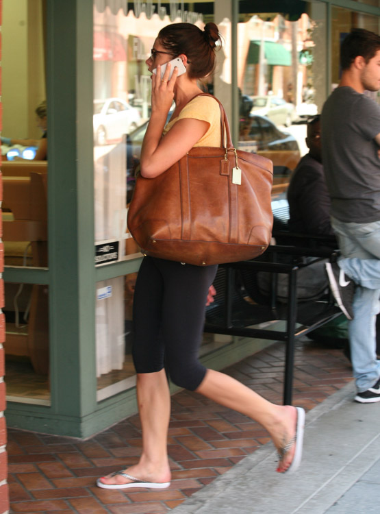 Coach Ashley Greene carries a Coach Bleecker Legacy Weekend Tote